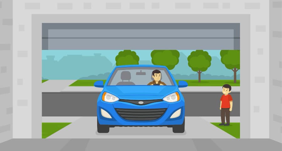 Image of a homeowner driving into his garage with a child watching.