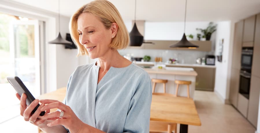 Woman using a cell phone in a modern home